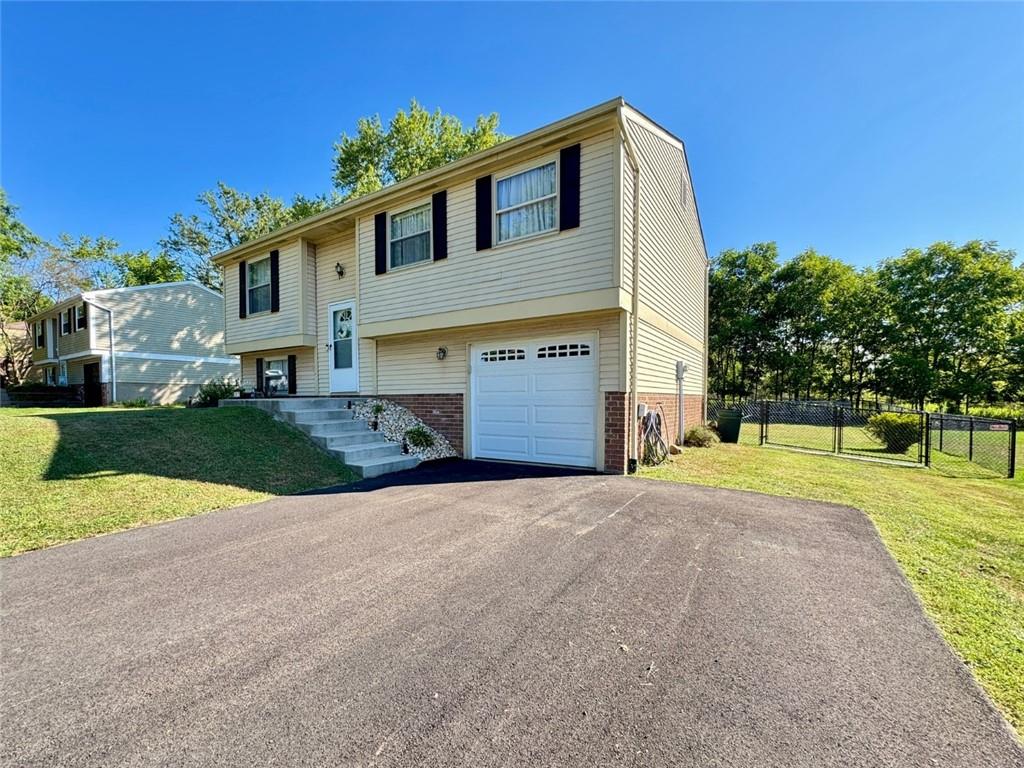 142 Partridge Run Road Gibsonia, PA 15044 - Photo 2 of 32 a front view of a house with a yard and garage