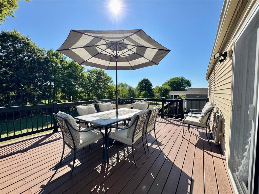 142 Partridge Run Road Gibsonia, PA 15044 - Photo 7 of 32 a view of patio with table and chairs under an umbrella with wooden floor