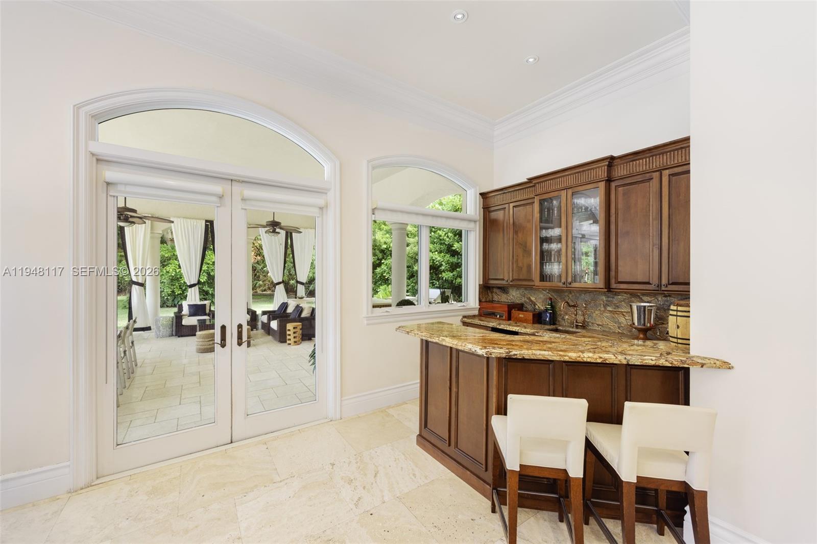 8252 School House Road Miami, FL 33143 - Photo 13 of 43 a view of a dining room with furniture and a potted plant