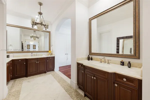 a spacious bathroom with a granite countertop sink mirror and a bathtub
