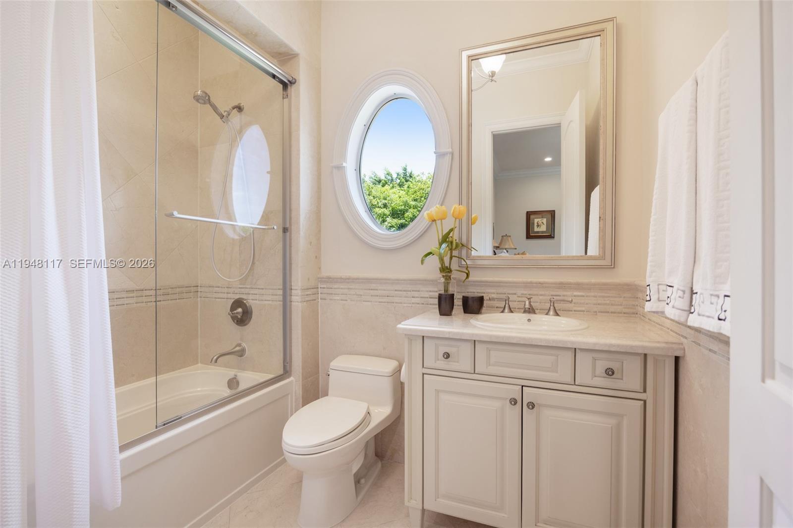 8252 School House Road Miami, FL 33143 - Photo 23 of 43 a bathroom with a sink a toilet and a mirror