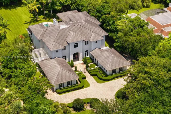 an aerial view of a house with garden space and street view