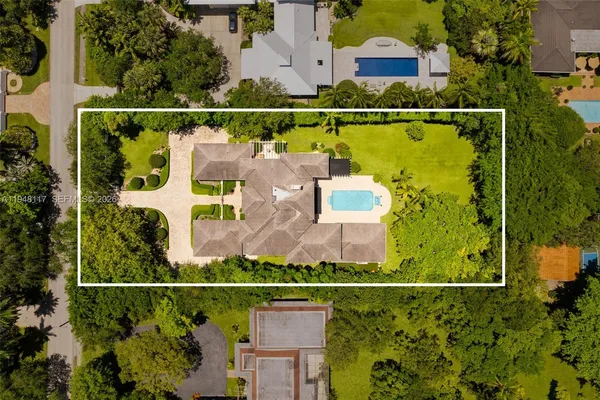 an aerial view of houses with a swimming pool