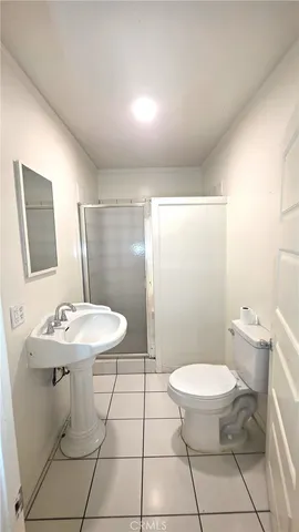 a view of an empty room and a bathroom