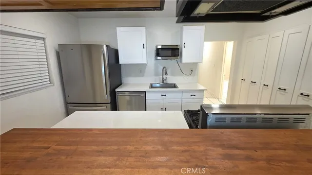 a stove top oven sitting inside of a kitchen