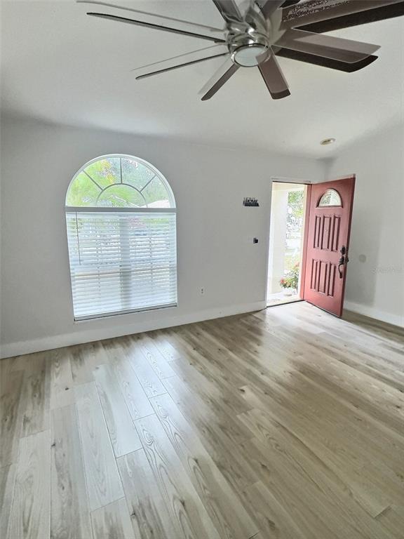 410 Maple Pointe Drive Seffner, FL 33584 - Photo 2 of 10 a view of empty room with wooden floor and fan