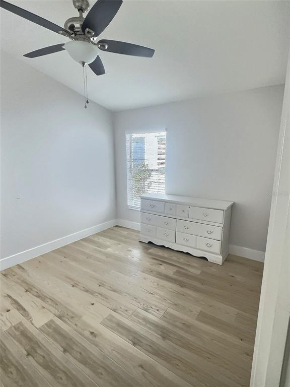 410 Maple Pointe Drive Seffner, FL 33584 - Photo 6 of 10 a view of empty room with wooden floor and fan