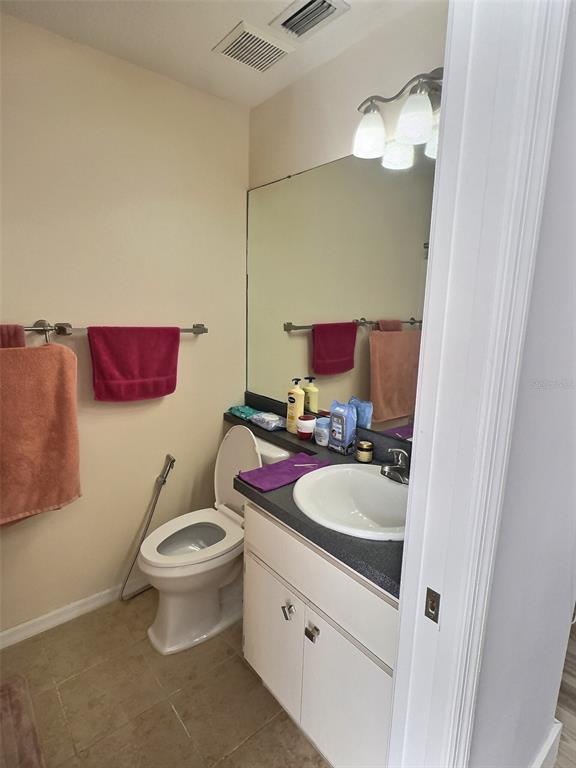 410 Maple Pointe Drive Seffner, FL 33584 - Photo 9 of 10 a bathroom with a toilet sink and mirror