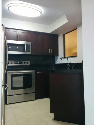 a view of a refrigerator in kitchen