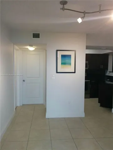 a metallic refrigerator freezer sitting in a kitchen