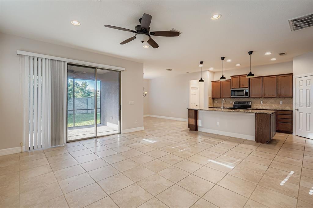 16355 Treasure Point Drive Wimauma, FL 33598 - Photo 13 of 28 a view of a kitchen with a sink and stainless steel appliances