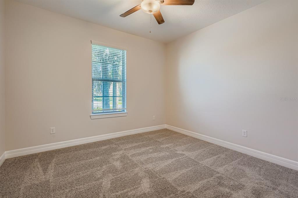 16355 Treasure Point Drive Wimauma, FL 33598 - Photo 20 of 28 an empty room with windows and fan