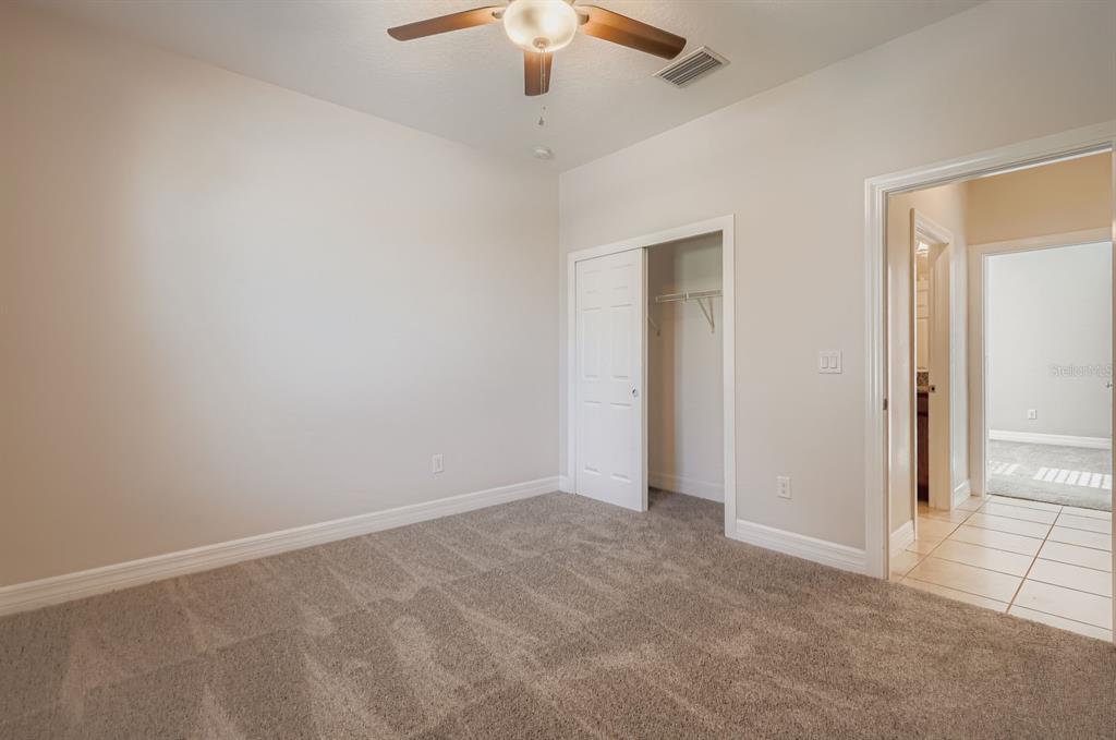 16355 Treasure Point Drive Wimauma, FL 33598 - Photo 21 of 28 an empty room with a empty space and a ceiling fan