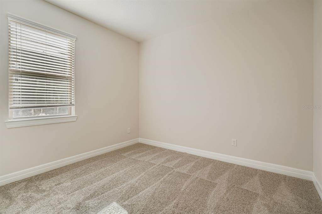 16355 Treasure Point Drive Wimauma, FL 33598 - Photo 22 of 28 an empty room with a window