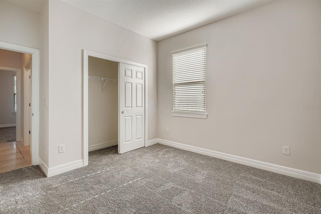 16355 Treasure Point Drive Wimauma, FL 33598 - Photo 23 of 28 an empty room with windows