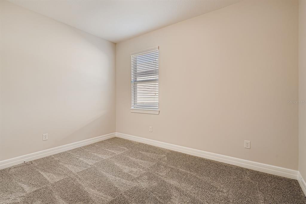 16355 Treasure Point Drive Wimauma, FL 33598 - Photo 24 of 28 an empty room with windows