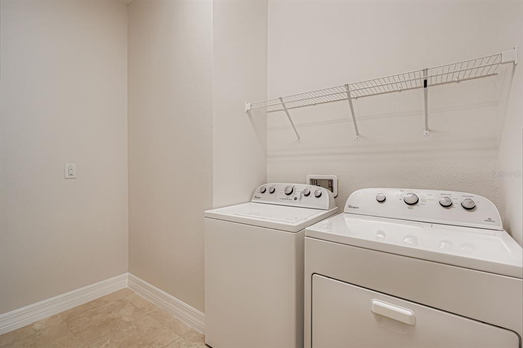 16355 Treasure Point Drive Wimauma, FL 33598 - Photo 27 of 28 a view of storage and utility room with washer and dryer