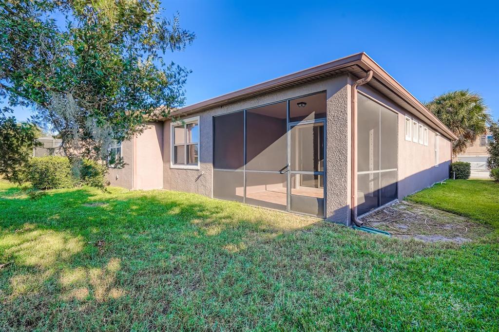 16355 Treasure Point Drive Wimauma, FL 33598 - Photo 3 of 28 a view of house with backyard and garden