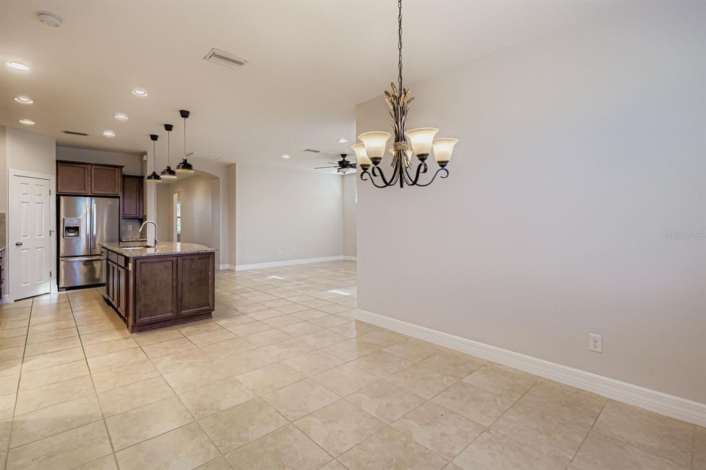 16355 Treasure Point Drive Wimauma, FL 33598 - Photo 7 of 28 a view of a kitchen with a sink and refrigerator