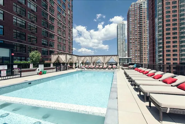 a view of a roof deck with couches and potted plants