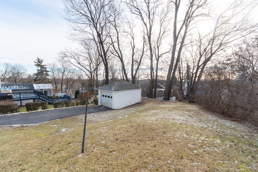29 Rob Roy Road Worcester, MA 01602 - Photo 30 of 31 a backyard of a house with garage and trees