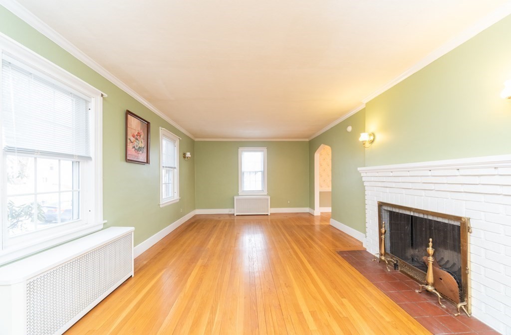 29 Rob Roy Road Worcester, MA 01602 - Photo 3 of 31 a view of empty room with wooden floor and fireplace