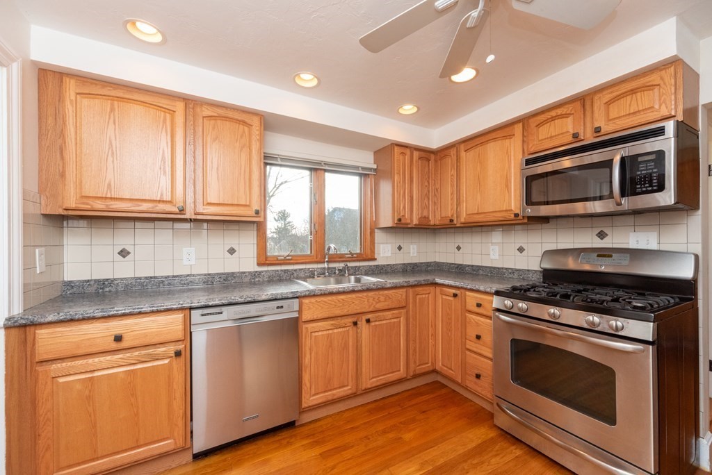 29 Rob Roy Road Worcester, MA 01602 - Photo 9 of 31 a kitchen with granite countertop wooden cabinets stainless steel appliances and a window