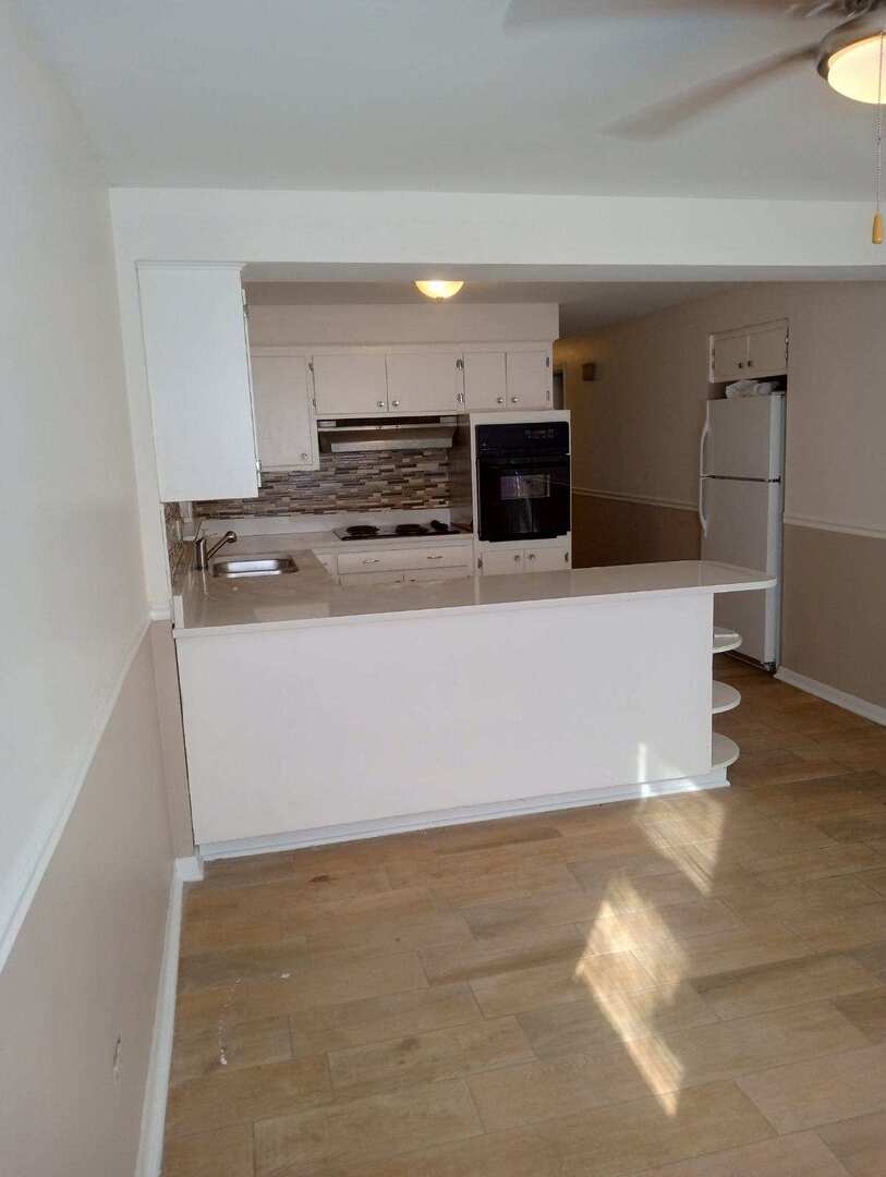 2915 West 79th Street, Unit G Chicago, IL 60652 - Photo 11 of 13 a view of kitchen with stainless steel appliances granite countertop cabinets and wooden floor