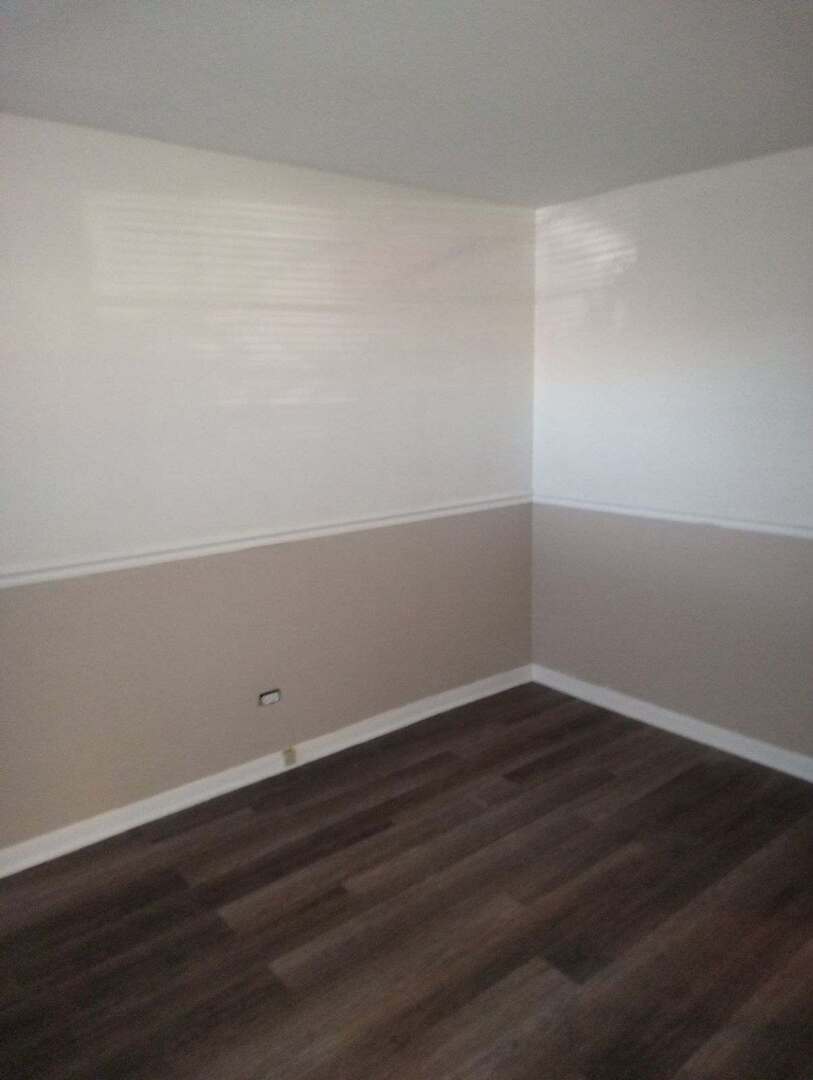 2915 West 79th Street, Unit G Chicago, IL 60652 - Photo 3 of 13 a view of an empty room with wooden floor