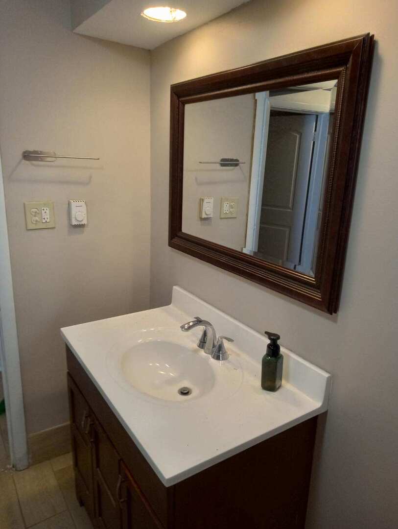 2915 West 79th Street, Unit G Chicago, IL 60652 - Photo 7 of 13 a bathroom with a sink vanity and mirror