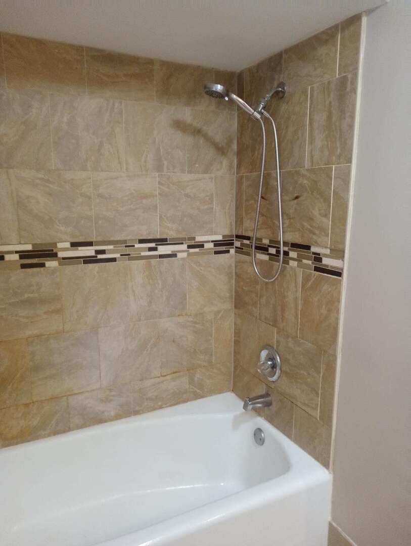 2915 West 79th Street, Unit G Chicago, IL 60652 - Photo 8 of 13 a bathroom with a shower and a bathtub