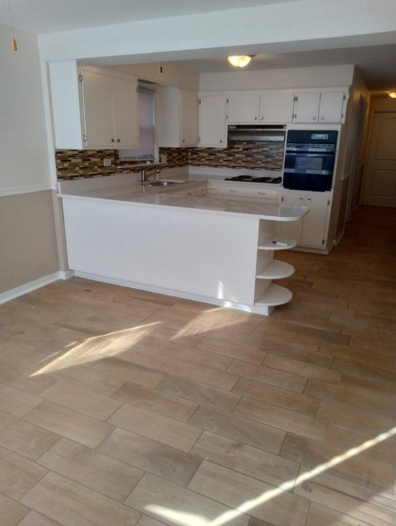 2915 West 79th Street, Unit G Chicago, IL 60652 - Photo 10 of 13 a view of kitchen with stainless steel appliances wooden floor