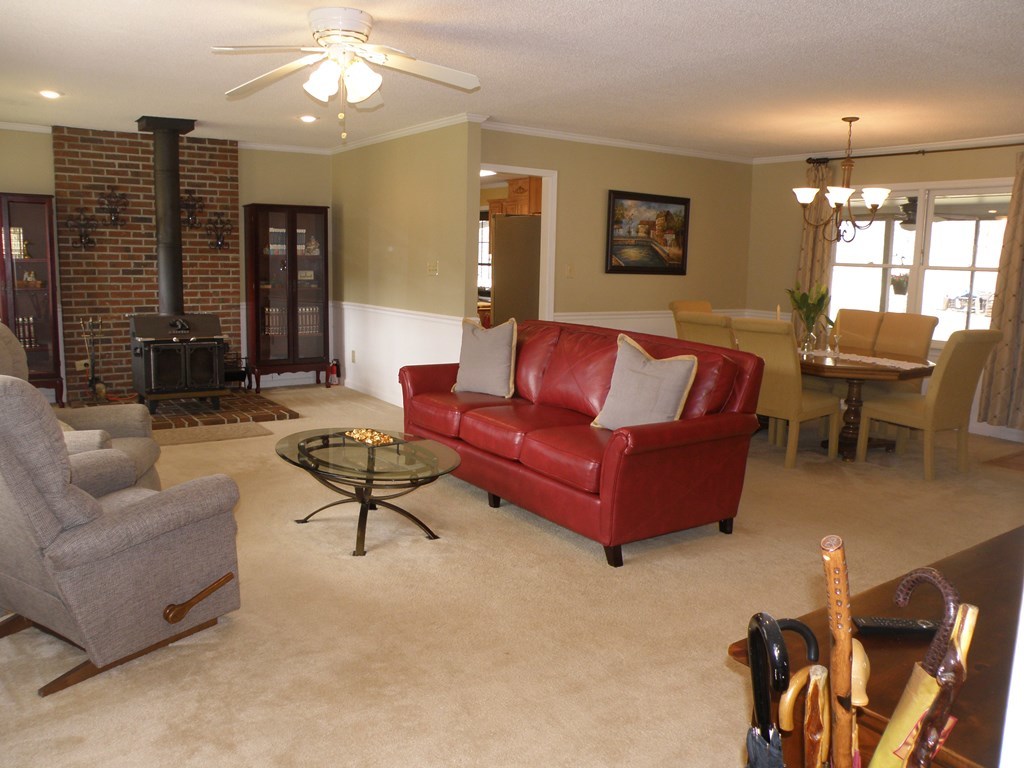 156 Plantation Road Gray, GA 31032 - Photo 7 of 48 a living room with furniture a chandelier and a large window