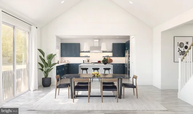 a view of a dining room with furniture and a potted plant