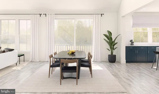 a view of a dining room with furniture and a window