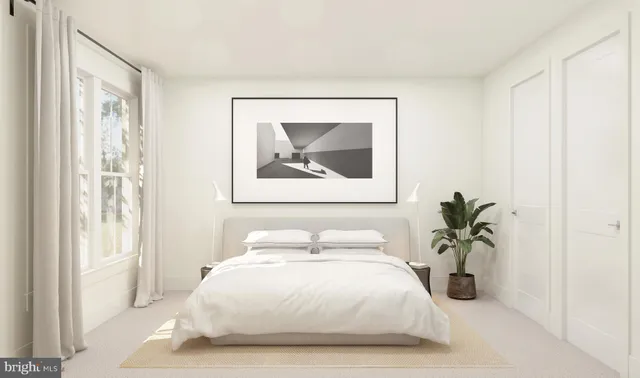a bedroom with a bed and a painting on the wall