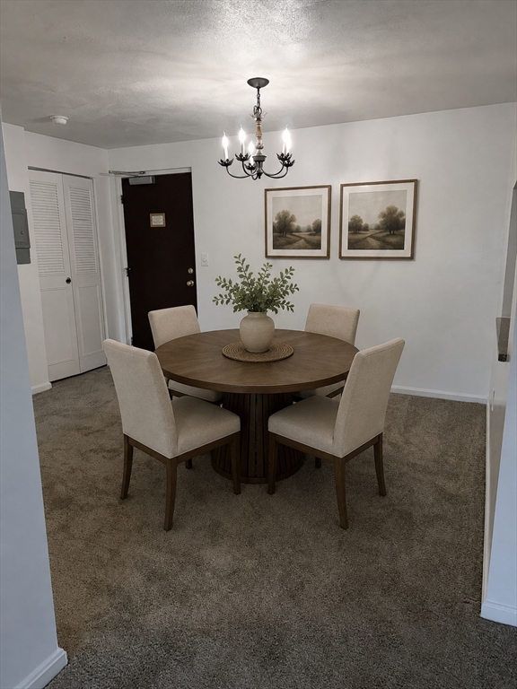 2 Victory Road, Unit 38 Lynn, MA 01902 - Photo 5 of 10 a view of a dining room with furniture and chandelier