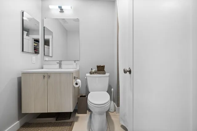 a bathroom with a toilet a sink and mirror
