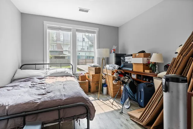 a bedroom with furniture and a window
