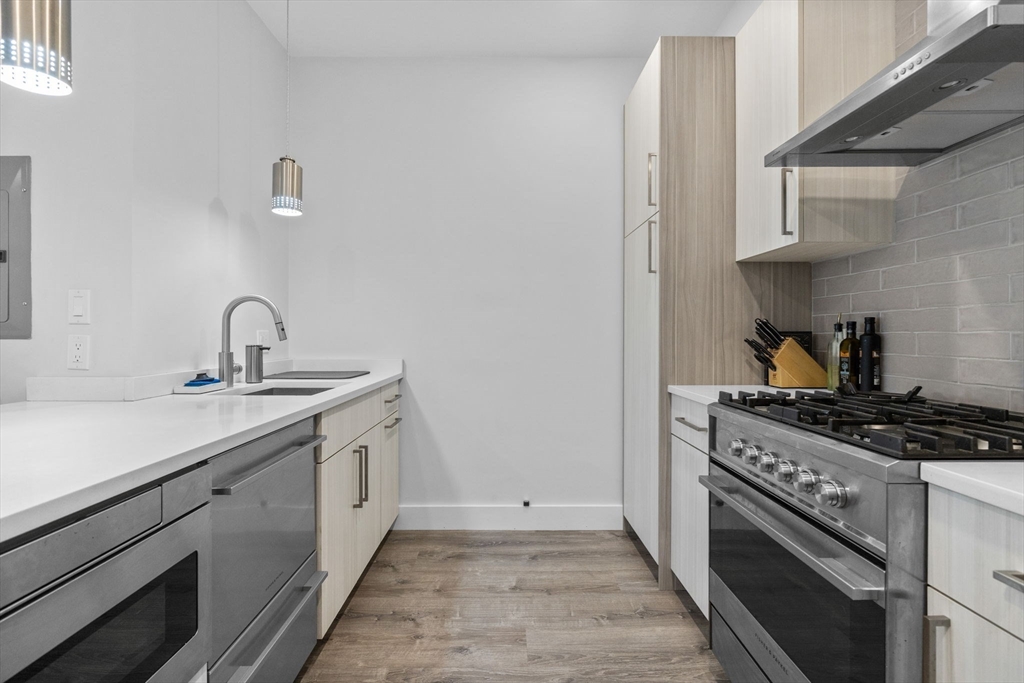 176 Humboldt Avenue, Unit 2 Boston, MA 02121 - Photo 3 of 23 a kitchen with a sink stove and cabinets