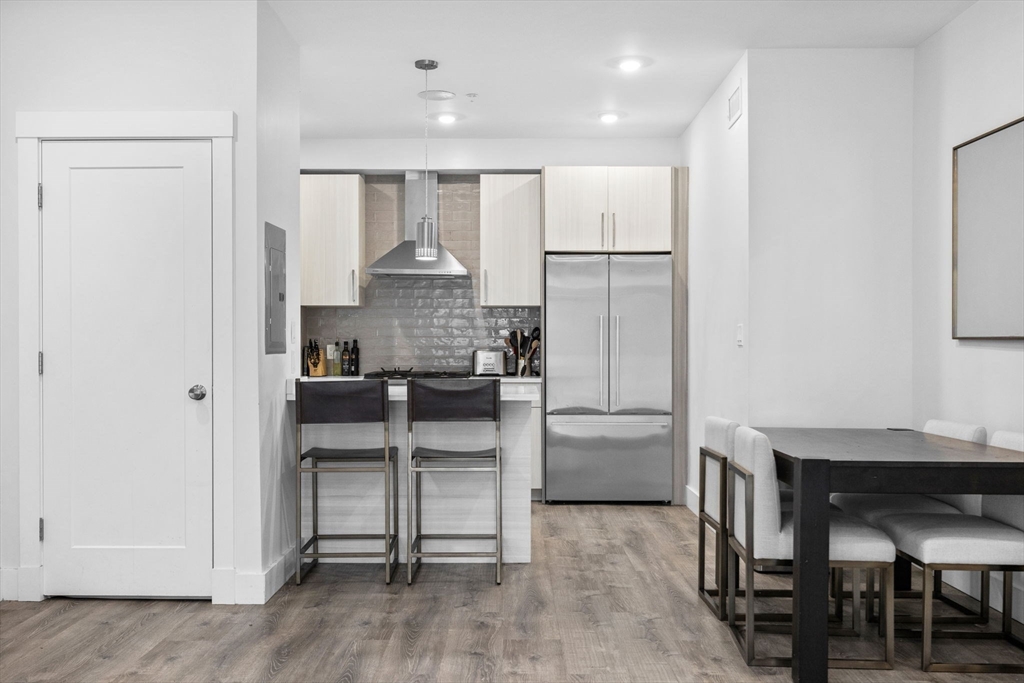 176 Humboldt Avenue, Unit 2 Boston, MA 02121 - Photo 4 of 23 a kitchen with stainless steel appliances a refrigerator and a stove top oven