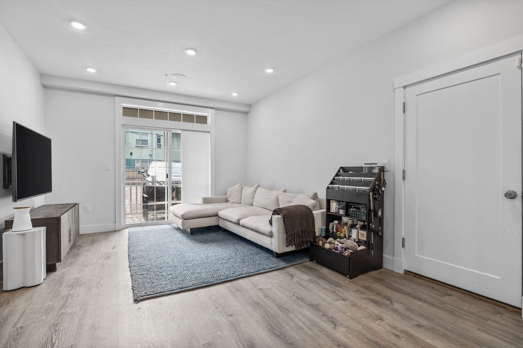 176 Humboldt Avenue, Unit 2 Boston, MA 02121 - Photo 7 of 23 a living room with furniture and a flat screen tv