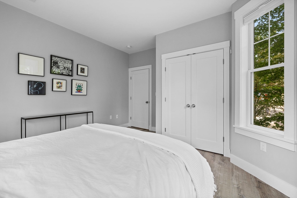 176 Humboldt Avenue, Unit 2 Boston, MA 02121 - Photo 10 of 23 a bedroom with a large bed and a window