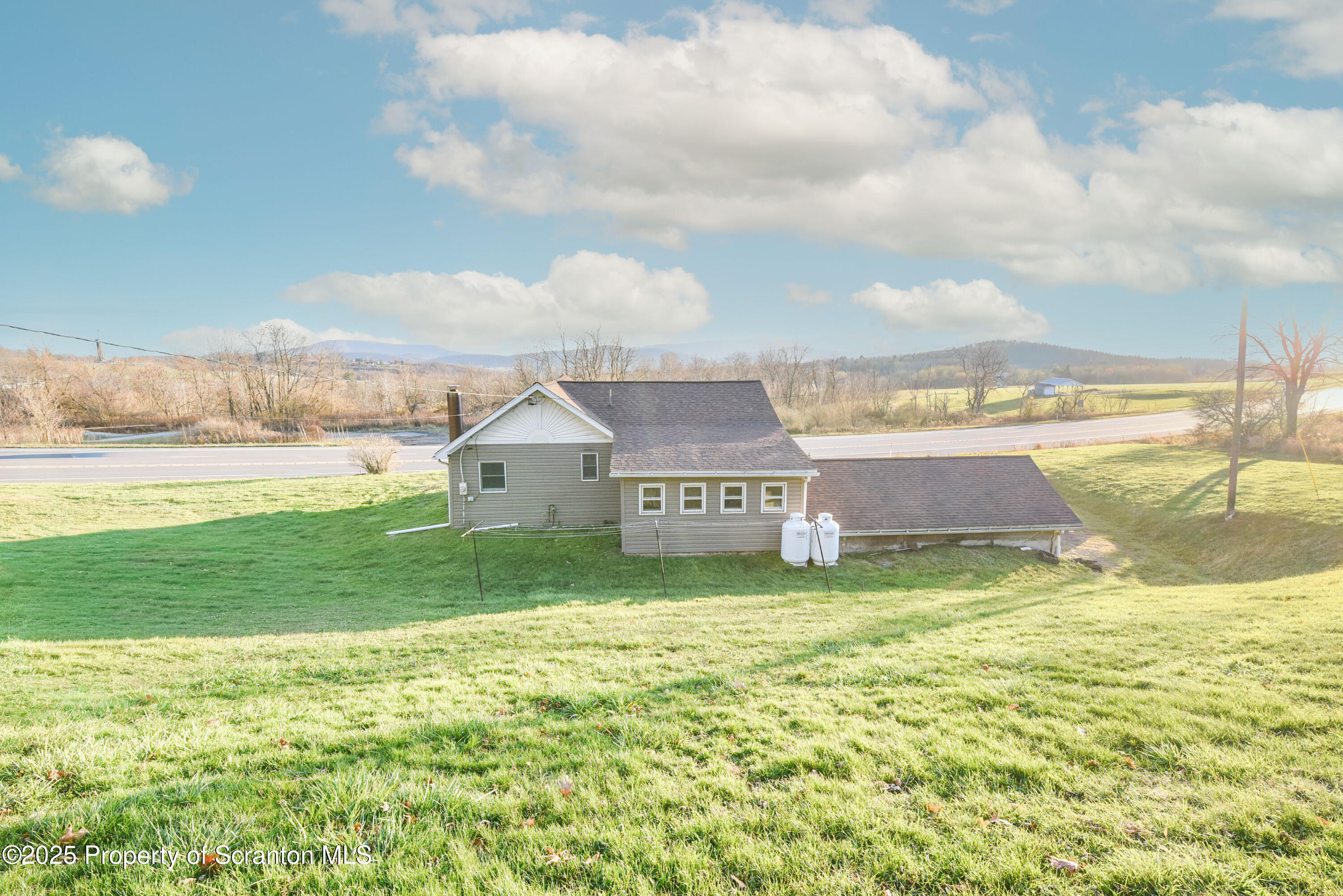 6193 Highway 87 Tunkhannock, PA 18657 - Photo 11 of 41 a view of a big room with a big yard and large trees
