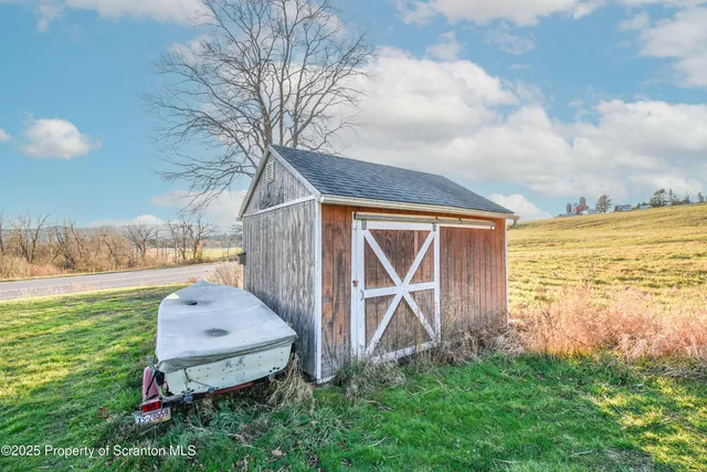 a backyard of a house with lots of green space and wooden fence