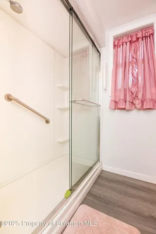 a bathroom with a toilet and a shower curtain