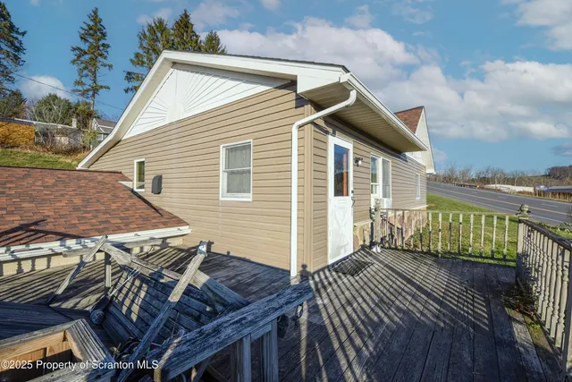 a view of a roof deck with wooden fence and wooden floor