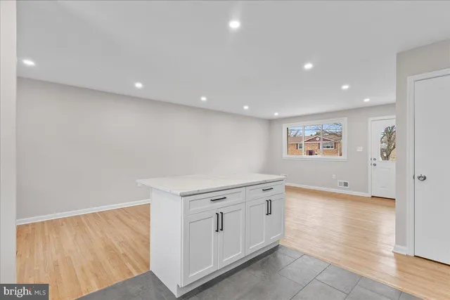 a view of a kitchen with white cabinets