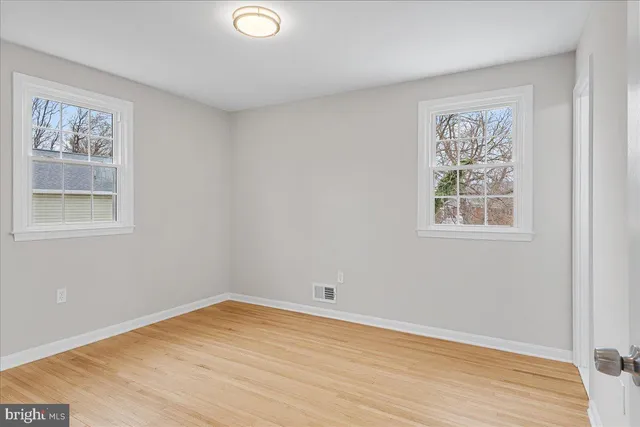 a view of a room with wooden floor and window