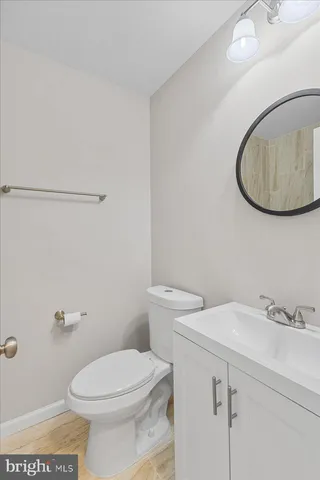 a white toilet sitting next to a bathroom sink